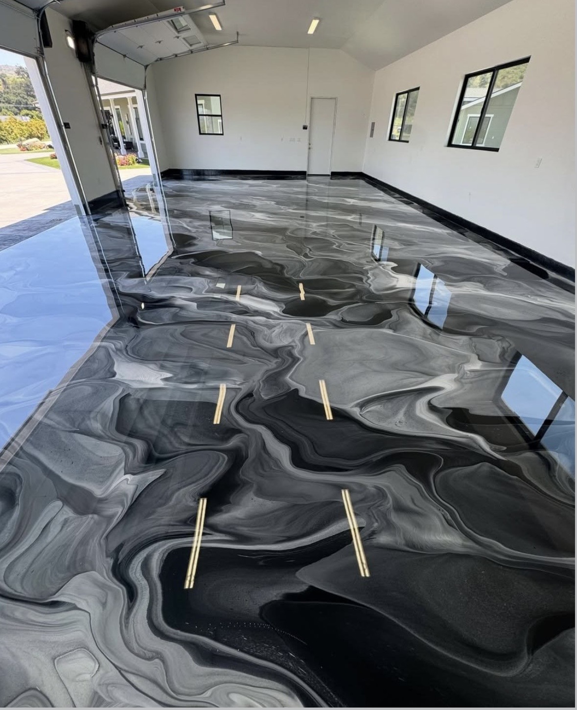 Hand-poured black and silver metallic epoxy garage floor with mirror gloss finish, Metro Atlanta